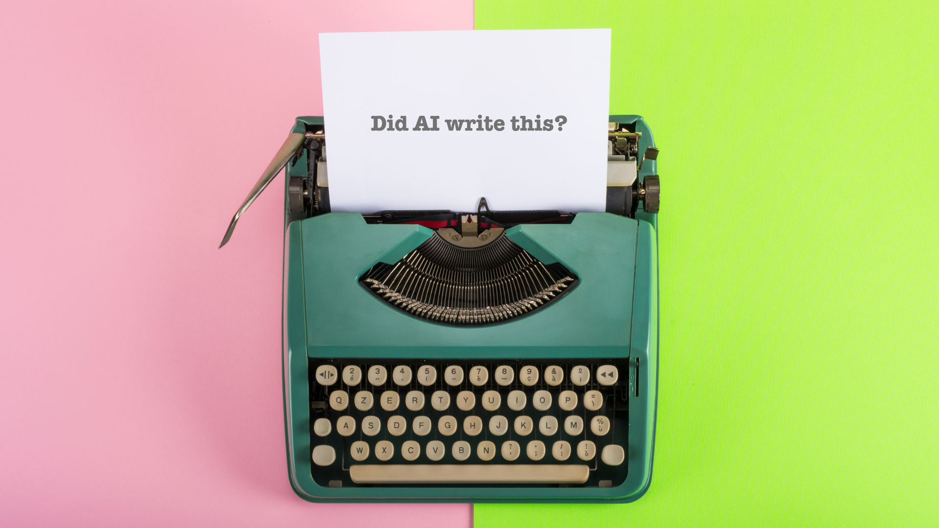 A turquoise vintage typewriter sits on a background that's half pink and half bright green. A piece of paper in the typewriter reads, "Did AI write this?"