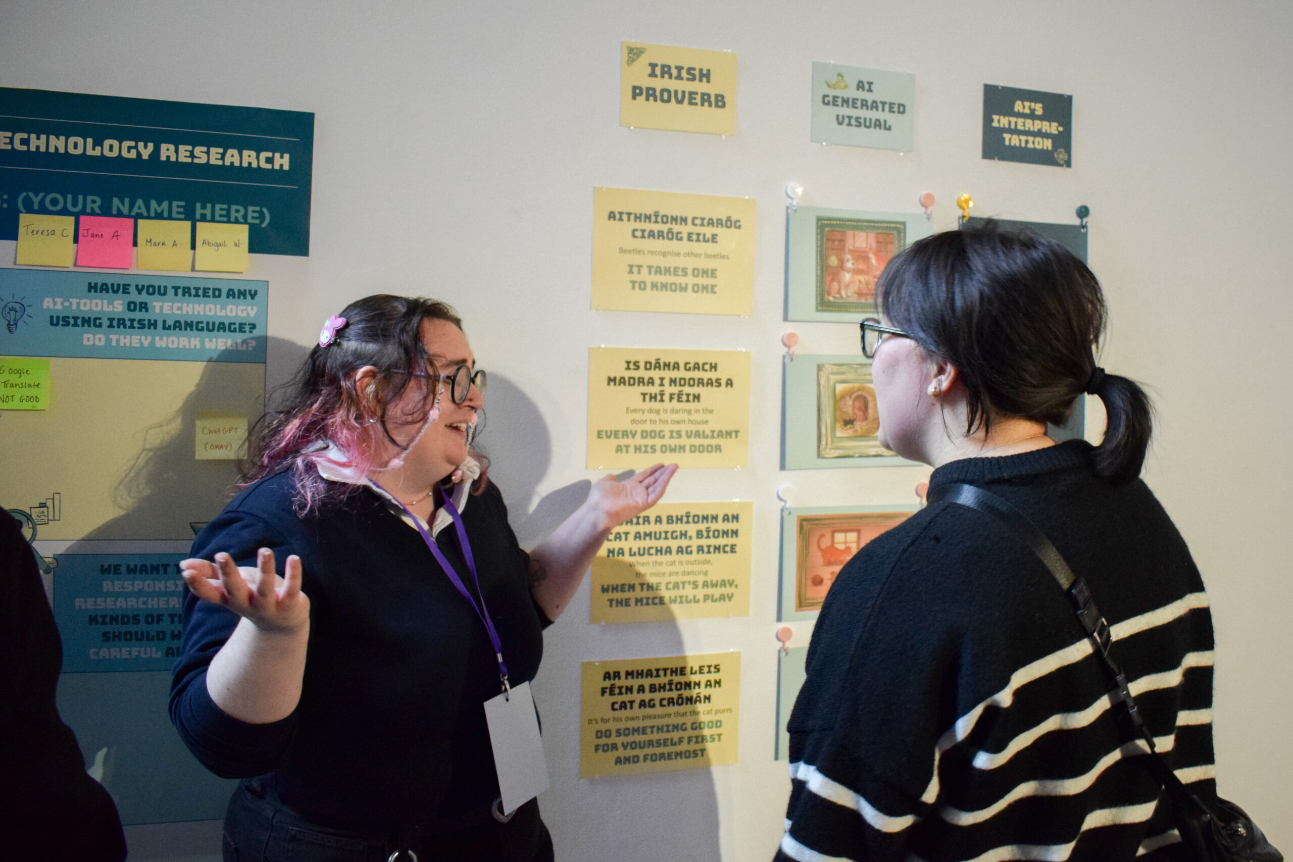 Two people interacting with a seanfhocail (Irish proverb) exhibition